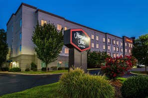 A Hampton Inn by Hilton hotel with a large sign, multiple windows, and well-maintained landscaping. - Hampton Inn Nashville Airport Century Place, TN (Nashville)