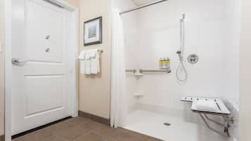 A bathroom with a shower, a toilet, and a sink.