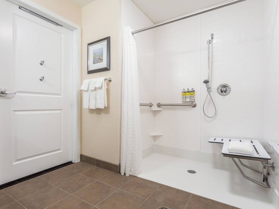 A bathroom with a shower, a toilet, and a sink.