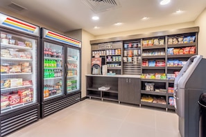 A convenience store with refrigerated sections, snack aisles, and a self-serve beverage machine. - Candlewood Suites Eau Claire I-94 by IHG (Eau Claire)