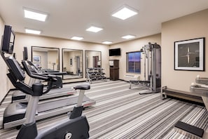 A gym with cardio equipment, weight machines, and mirrors. - Candlewood Suites Eau Claire I-94 by IHG (Eau Claire)