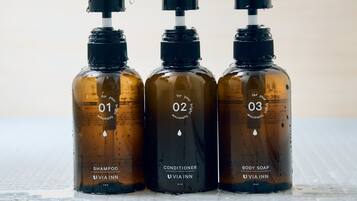 Three bottles of VIA INN products on a tiled surface.