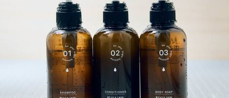 Three bottles of VIA INN products on a tiled surface.