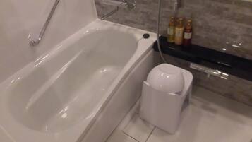 A modern bathroom with a bathtub, a shower, and a toilet.