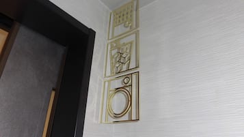 A wall with three geometric wall art pieces.