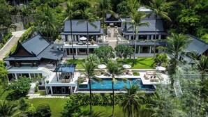 A large, multi-story resort with a swimming pool, palm trees, and a traditional architectural style. - Villa Analaya (Kamala)