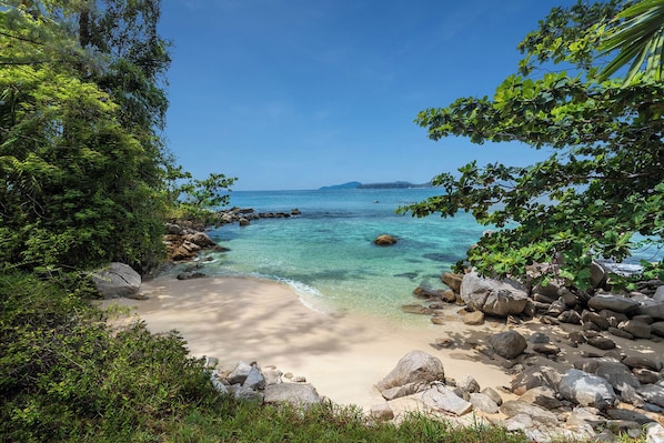 On the beach, white sand, sun-loungers, beach umbrellas