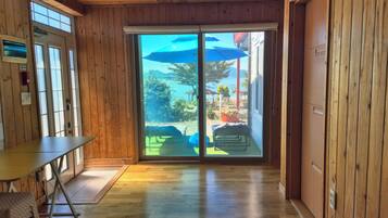 A wooden interior with a sliding glass door leading to an outdoor area.