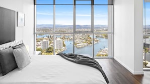 A bedroom with a large window offering a city and water view. - Holiday Holiday Chevron Renaissance (Surfers Paradise)