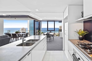Deluxe Apartment, 2 Bedrooms, 2 Bathrooms, Ocean View (level 24) | Private kitchen | Full-sized fridge, microwave, oven, stovetop - Holiday Holiday Circle On Cavill (Surfers Paradise)