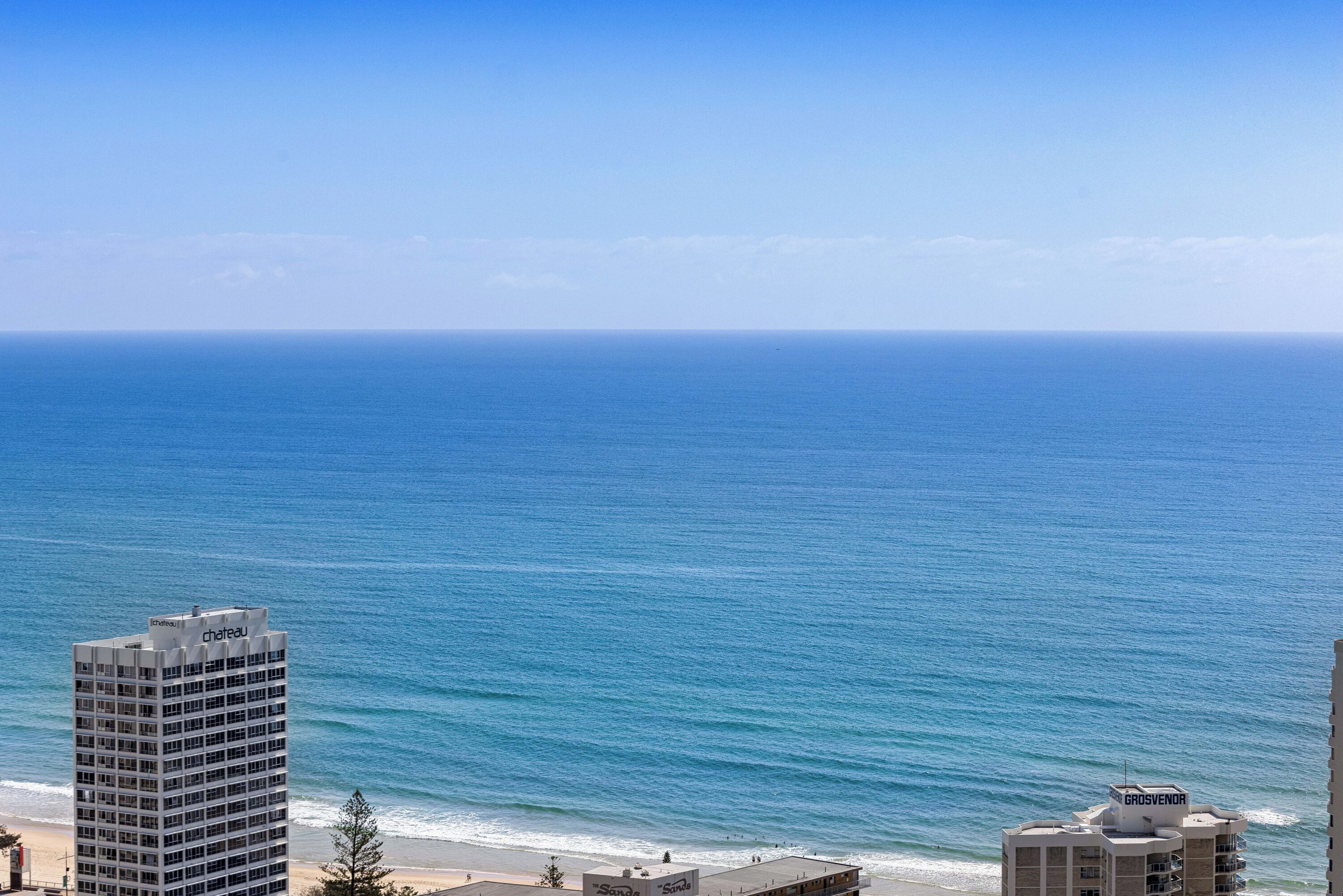 A high-rise hotel with a view of the ocean.