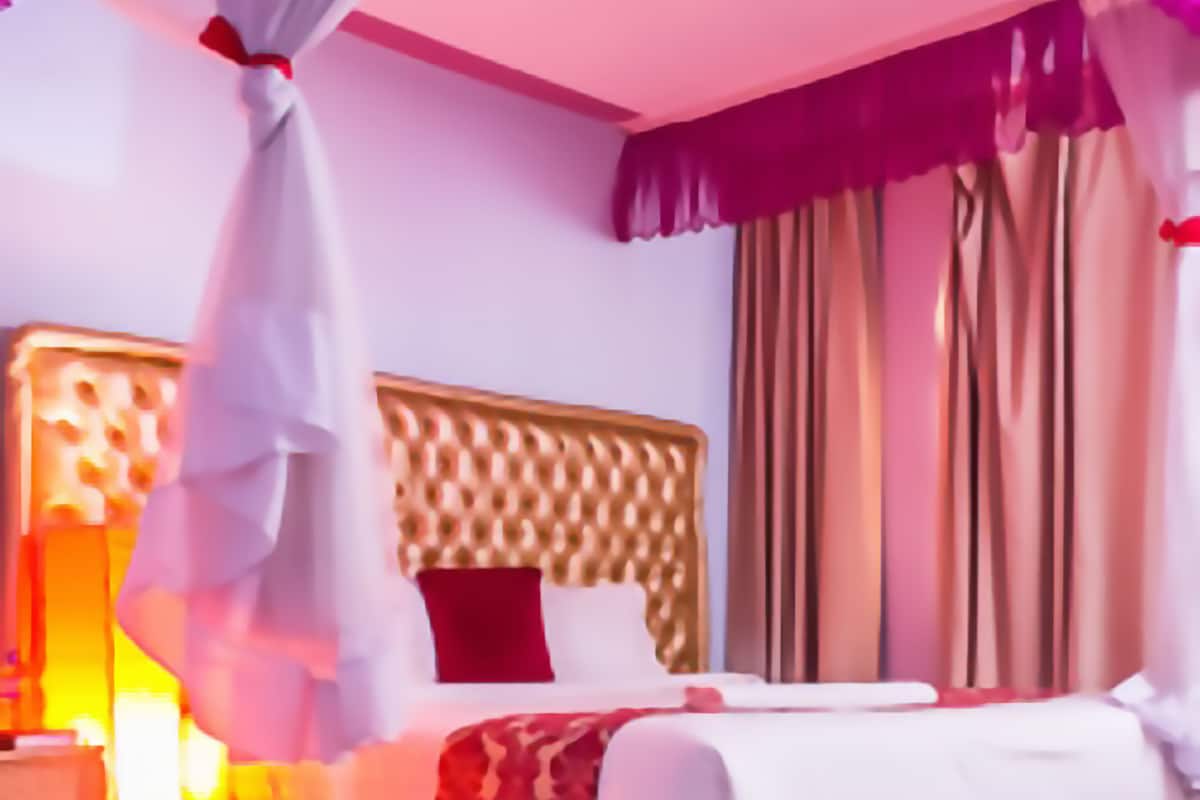 A bedroom with a wooden bed, a bedside table, and a nightstand.
