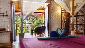 A room with a bed, a chair, and a table. - Bamboo Jam (Koh Rong Sanloem)