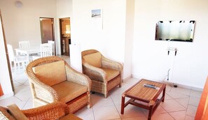 Standard Quadruple Room, 2 Bedrooms | Living area | Flat-screen TV