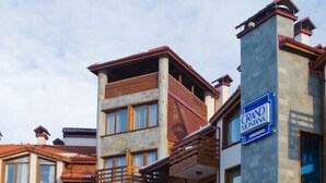 A multi-story hotel with a prominent sign reading "GRAND MONANNA". - Grand Montana (Bansko)