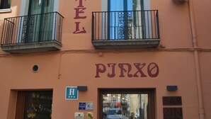A hotel named "HOTEL PUNXO" with balconies, a bar, and a visible entrance. - Hotel Pinxo (Santa Coloma de Farners)