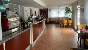 Un moderno vestíbulo de hotel con área de bar, asientos y vistas de la ciudad.