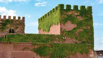 A historic building with ivy-covered walls and a prominent tower.