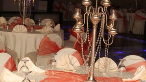 A banquet table set with white tablecloths, red sashes, and silver candelabras. - Jeddah Palace Hotel (Amman)