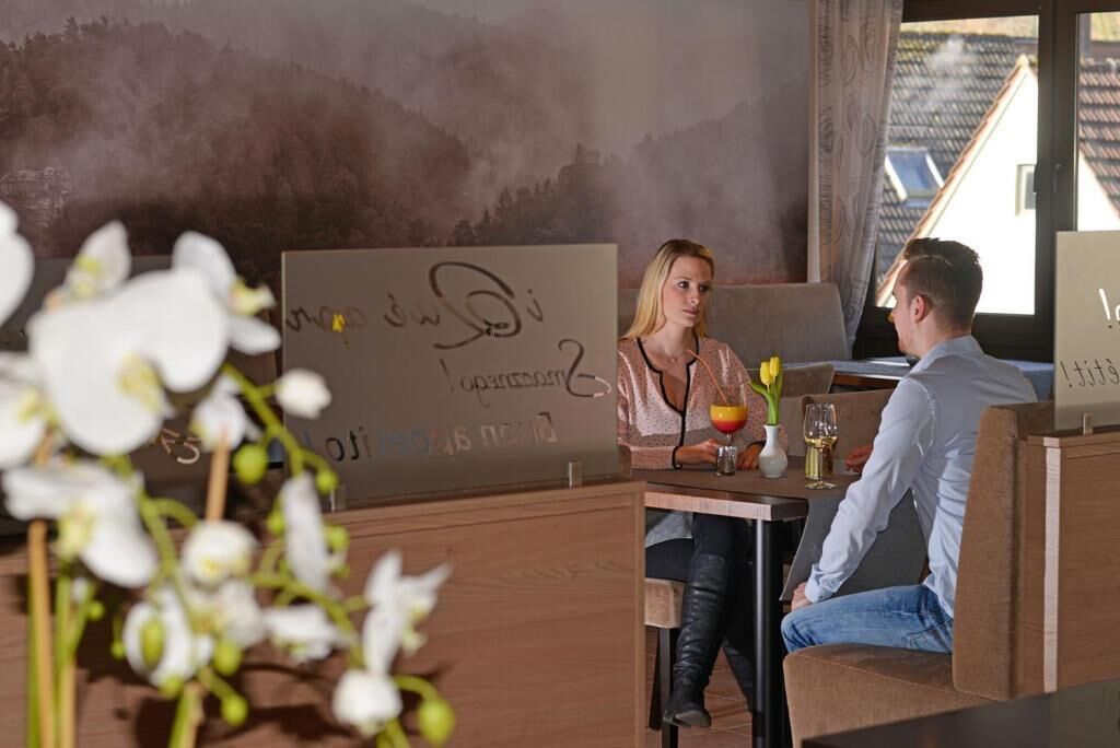 A restaurant with a rustic interior, a wooden table, and a view of the outdoors.