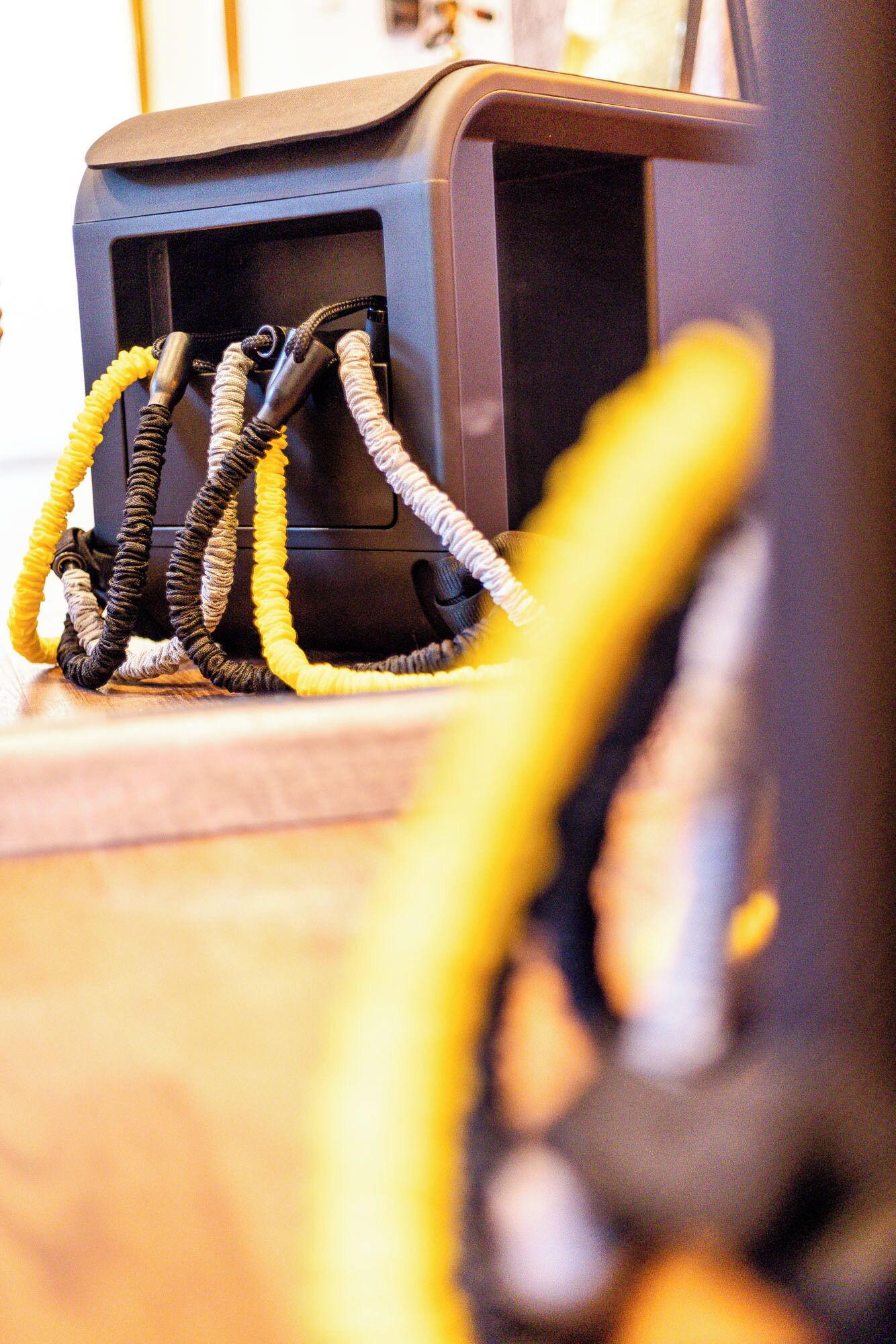 A close-up of a black device with multiple cables connected to it.