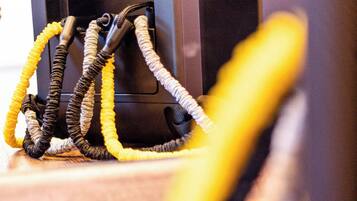 A close-up of a black device with multiple cables connected to it.