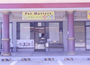 A pet clinic named 'Pet Matters' with a signboard, a bench outside, and a glass door. - Butuan Grand Palace Hotel Annex (Butuan)