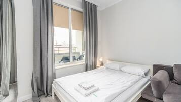 Chambre Quadruple, 2 lits doubles, balcon | Coin séjour