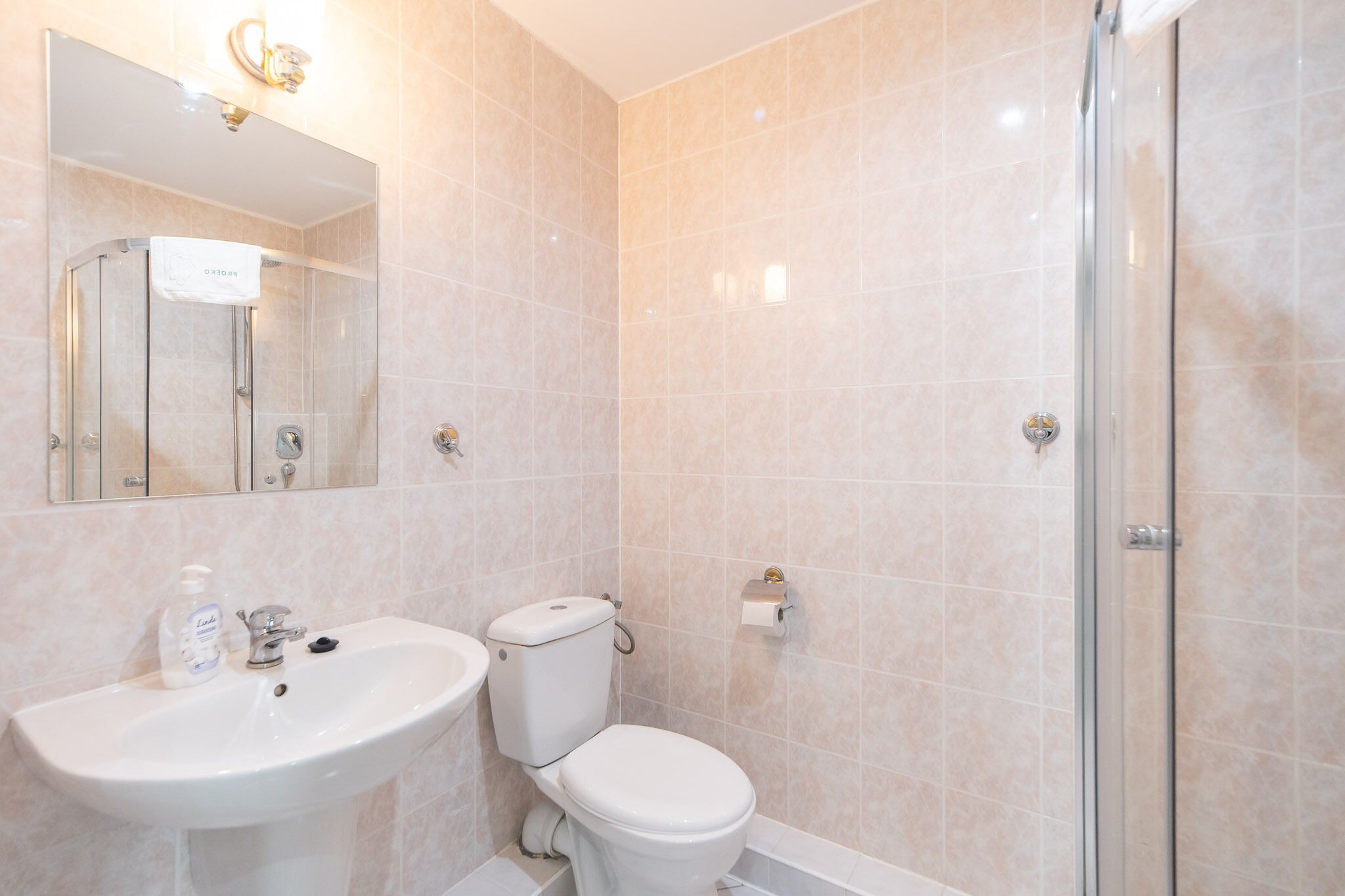 A bathroom with a sink, toilet, and shower.
