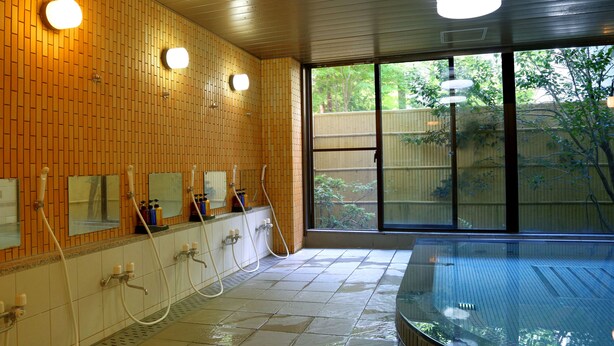 A bathroom with wooden paneling, multiple sinks, and a large glass-enclosed hot tub. - Asia Hotel Fujisan (Yamanakako)
