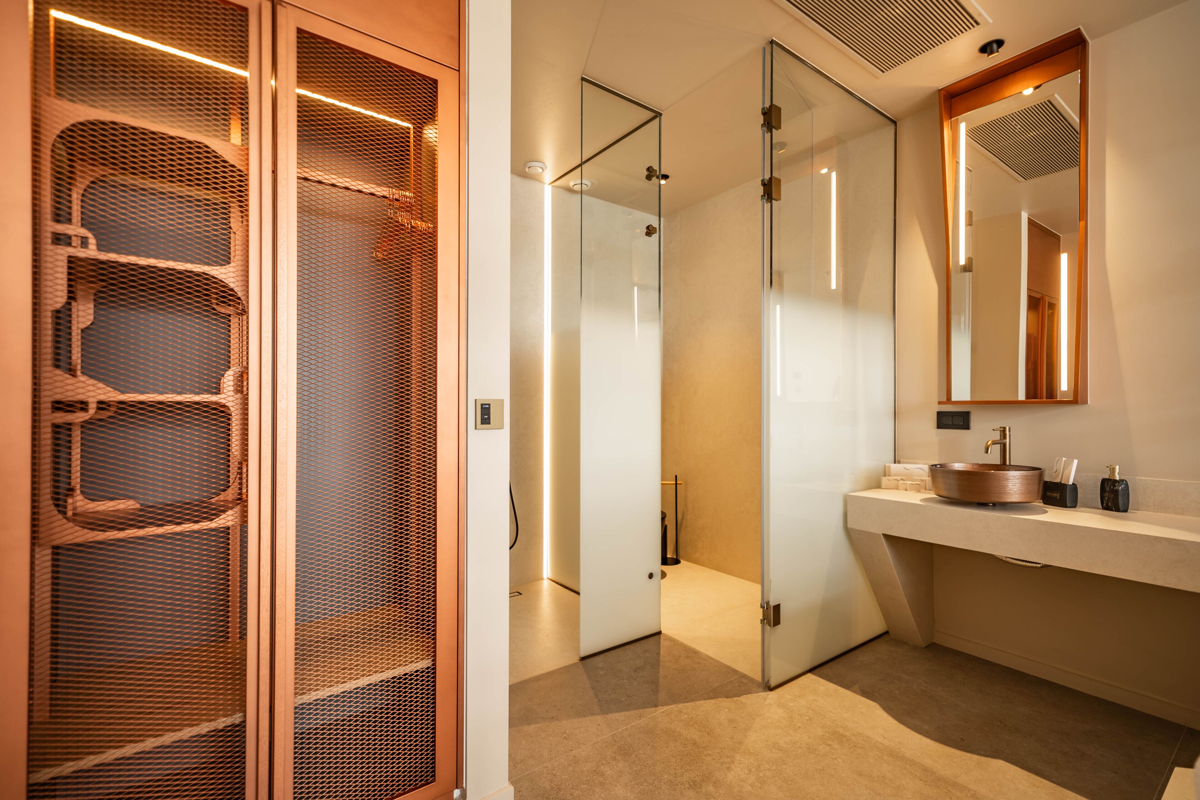 A modern bathroom with a glass shower enclosure, a wooden vanity, and a large mirror.