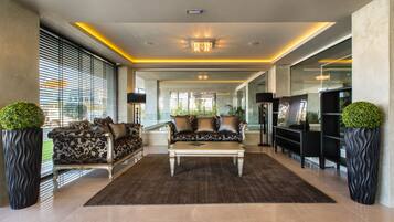 A spacious living area with a sofa set, a coffee table, and a TV.