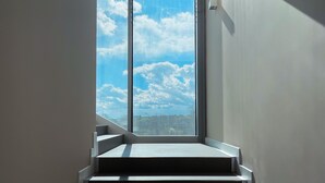 A staircase leading to a balcony with a cityscape view. - La Perla (Camerano)