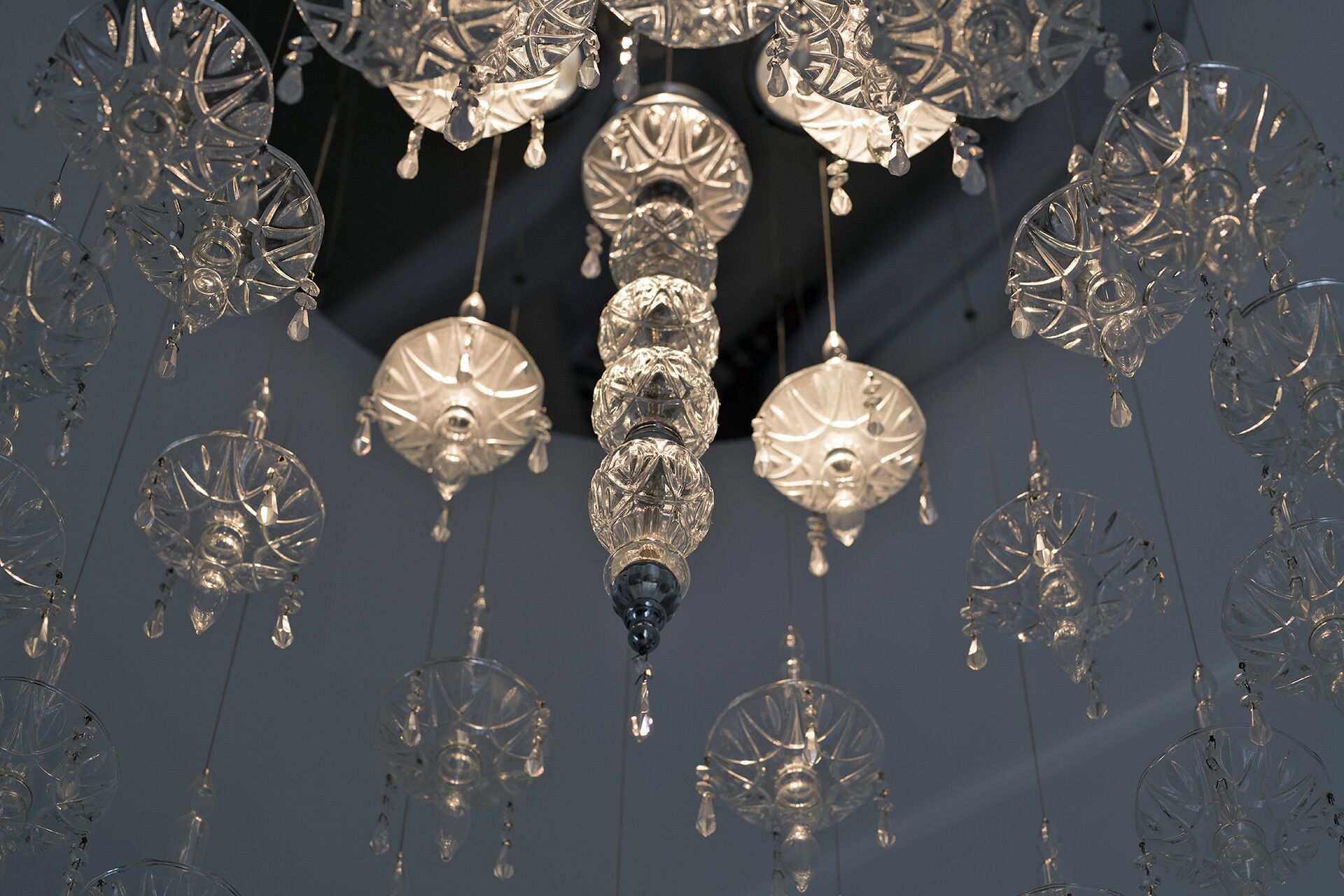 A chandelier with multiple crystal elements and hanging crystals.