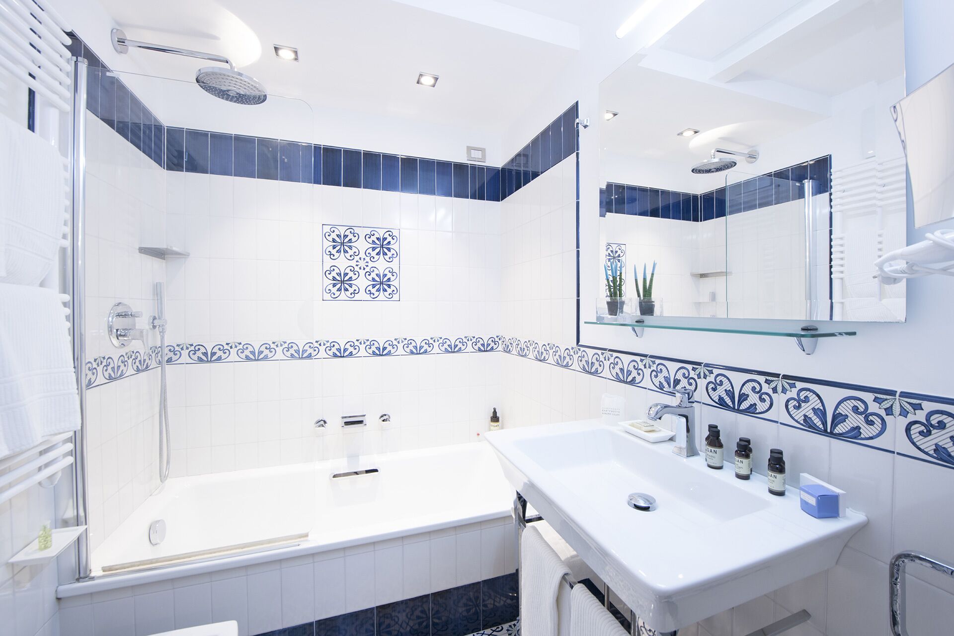 A modern bathroom with a bathtub, a sink, and a shower area.