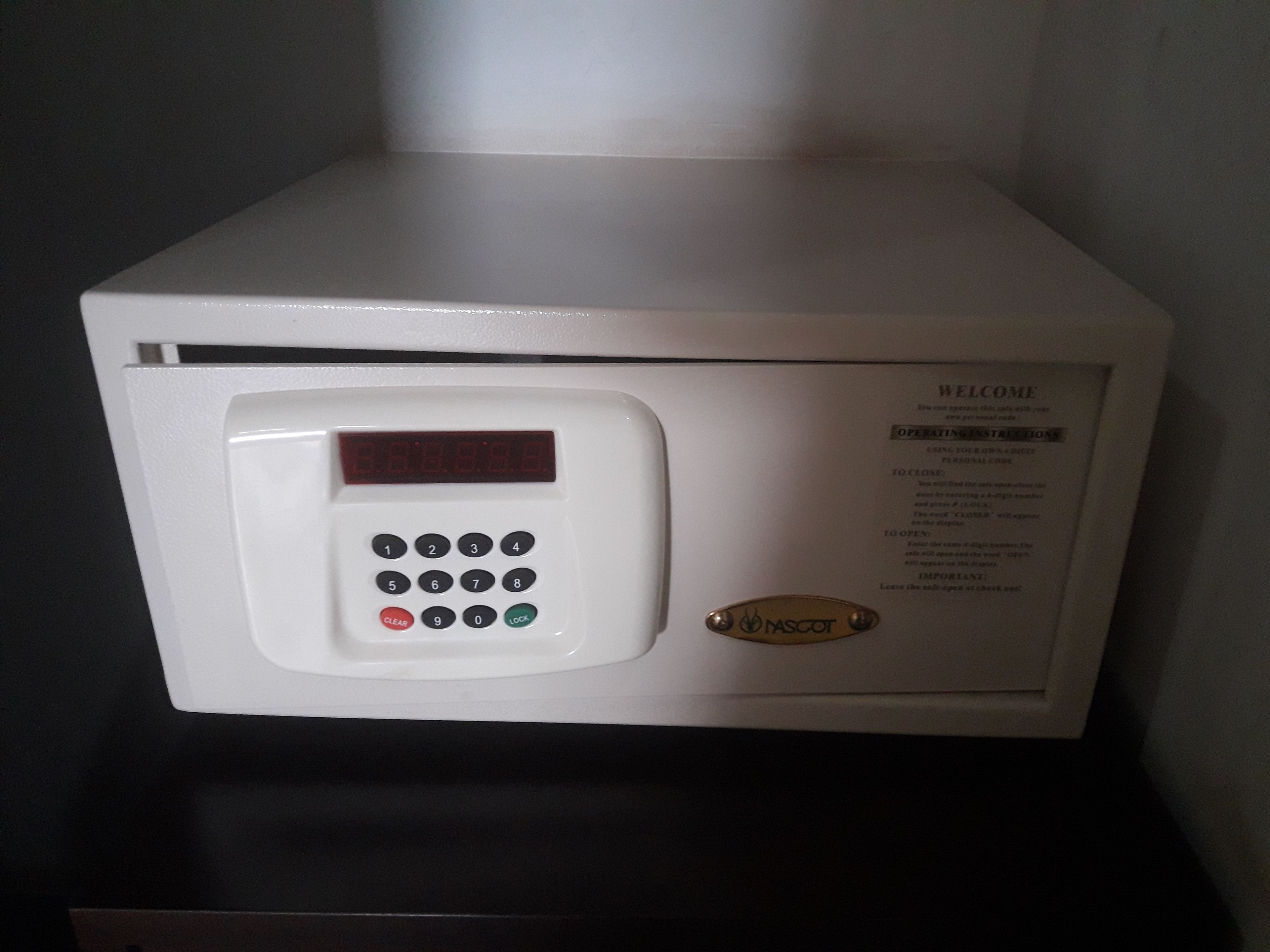 En hvid mikrobølgeovn med digitalt display og kontrolpanel.