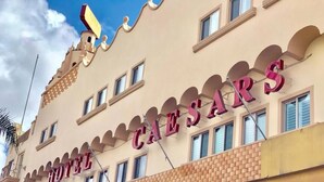 A hotel with a distinctive architectural design, featuring arched windows and a prominent sign reading "HOTEL CAESARS". - Hotel Caesar's (Tijuana)