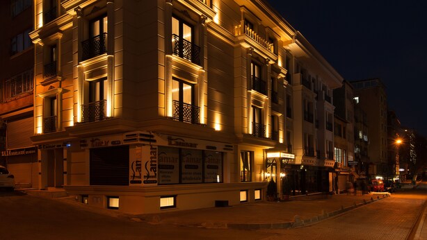 A historic building with ornate architectural details, large windows, and a ground-level commercial space with signage.