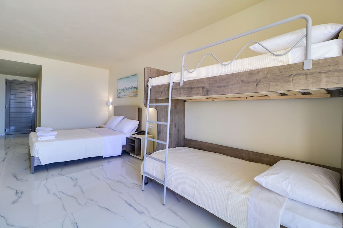 Quadruple Room, Sea View | Free minibar, in-room safe, blackout drapes, soundproofing