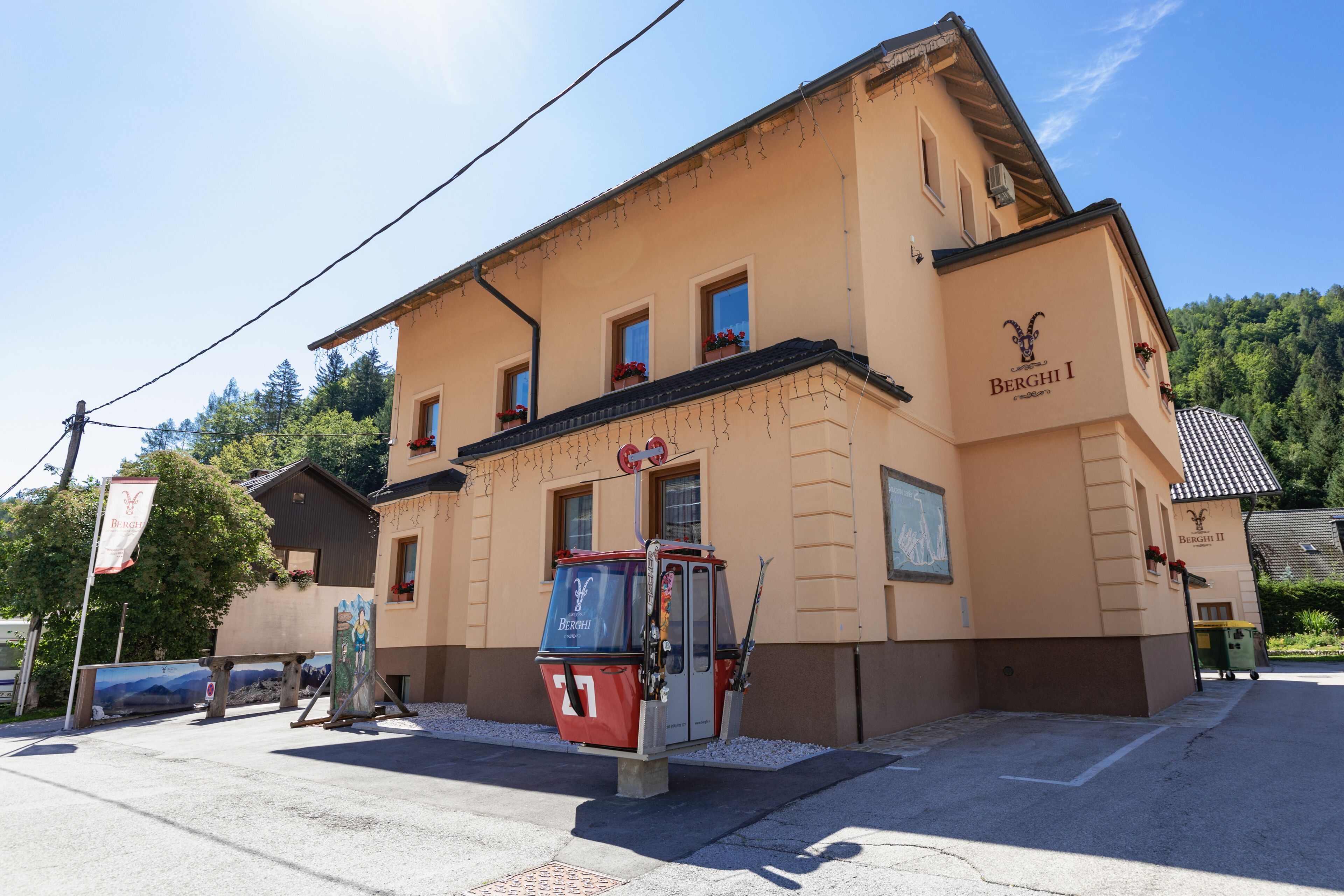 A building with a sign reading "Berghi I" and a ski lift in front.