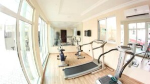 A gym with treadmills, stationary bikes, and exercise equipment. - Celia's Suites (Abeokuta)