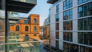 A modern building with large windows and a glass balcony.