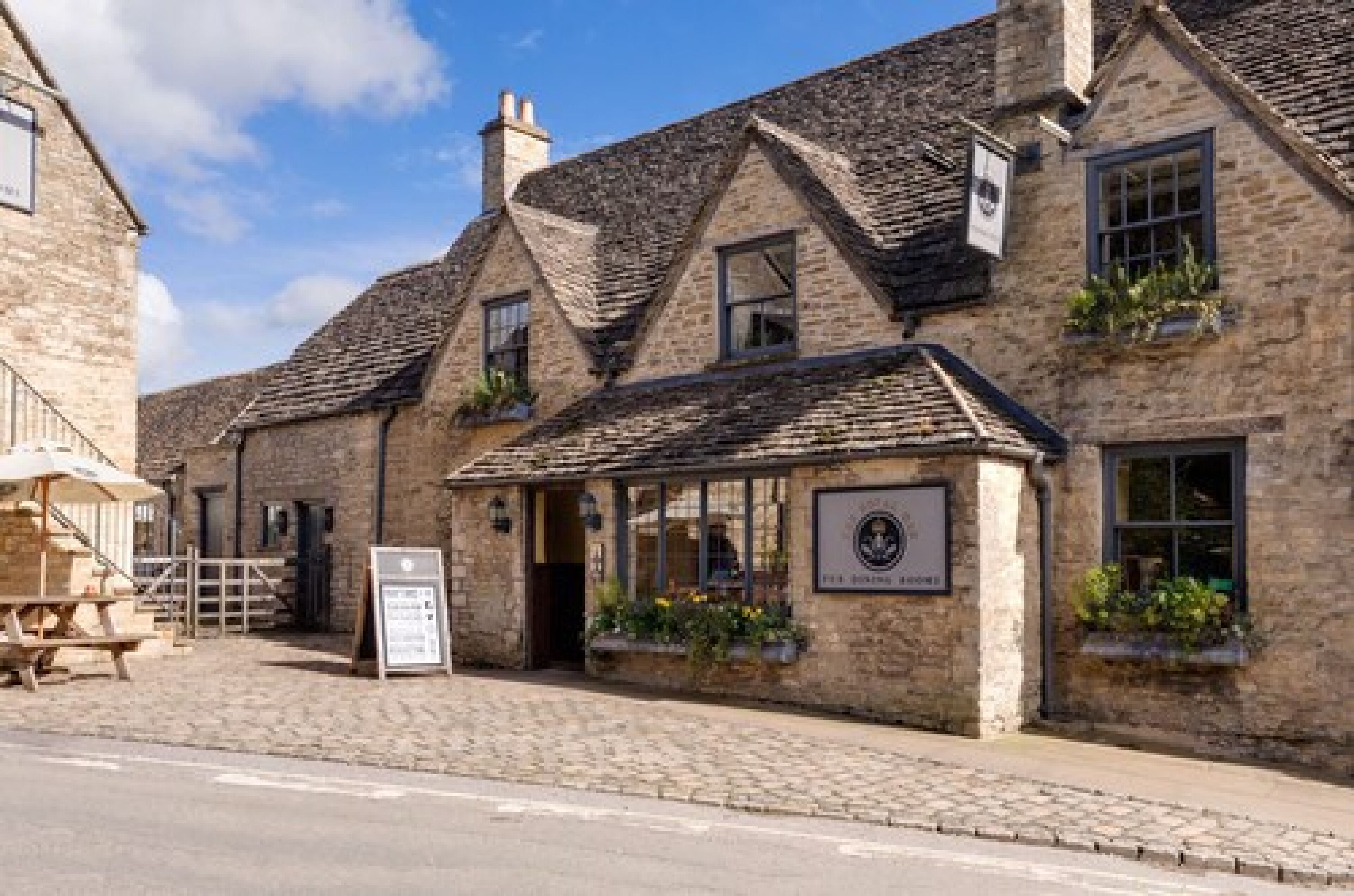 A traditional stone building with a sign indicating it is a pub.