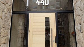 A building facade with a sign reading "San Martin Design" and the number "440" above a wooden door. - Urbana Suites & Studios 440 (San Carlos de Bariloche)