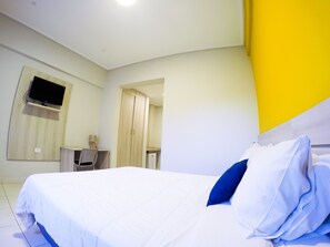 A hotel room with a bed, a desk, a television, and a wardrobe. - Nova Hotel (Ciudad Del Este)