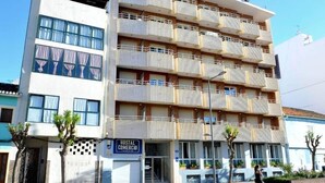 A multi-story building with a sign for 'Hostal Comercio' indicating a commercial space on the ground floor. - Hostal Comercio (Denia)