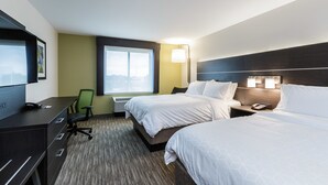 A hotel room with two beds, a desk, a chair, a TV, and a window with a view.