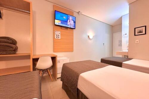 Executive Triple Room | Desk, laptop workspace, blackout curtains, free WiFi