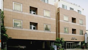 A multi-story hotel with a prominent red sign reading "KOGA CENTRAL HOTEL". - Koga Central Hotel (Koga)