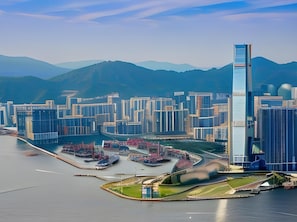 A modern cityscape with high-rise buildings, a waterfront area, and a prominent skyscraper. - Acesite Knutsford Hotel (Kowloon)